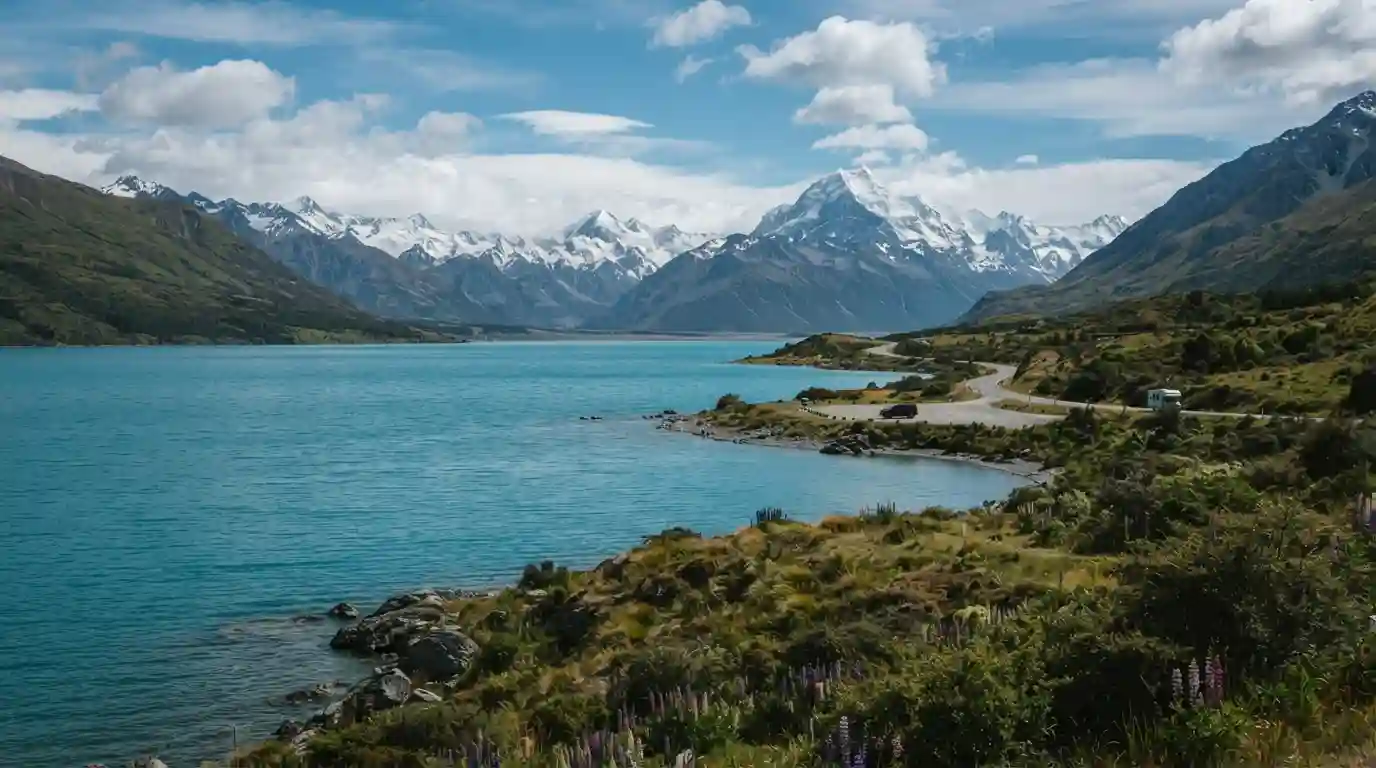 New Zealand alpine landscape with a turquoise lake and snow-capped Southern Alps