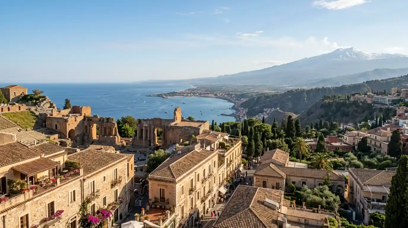 Taormina's historic rooftops overlooking the Ionian Sea with Mount Etna in the distance.