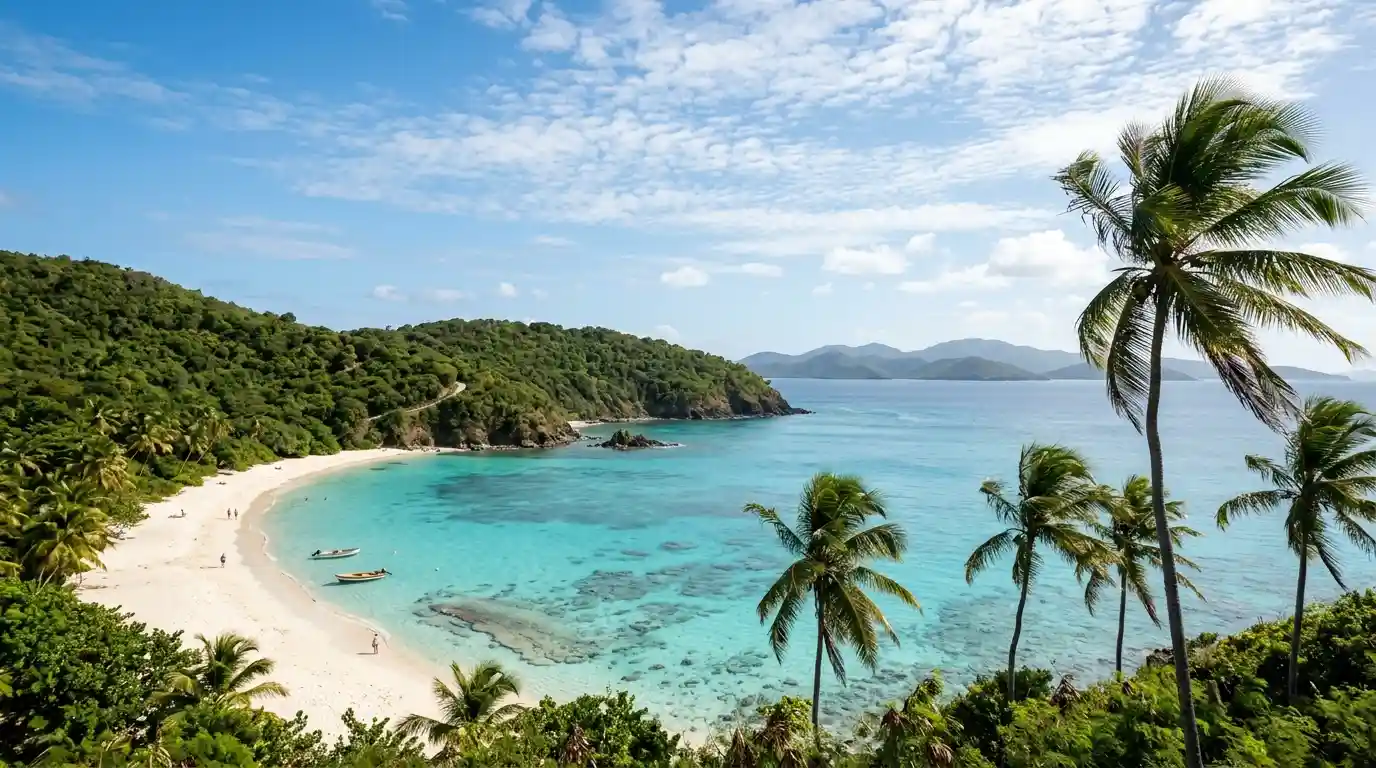 White-sand Caribbean beach with turquoise water and green tropical hills in the U.S. Virgin Islands.