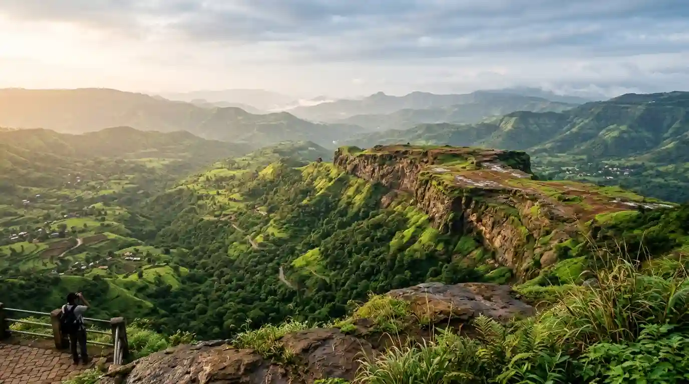 Panoramic view of green hills and a rocky plateau in the Panchgani and Mahabaleshwar region of Maharashtra.