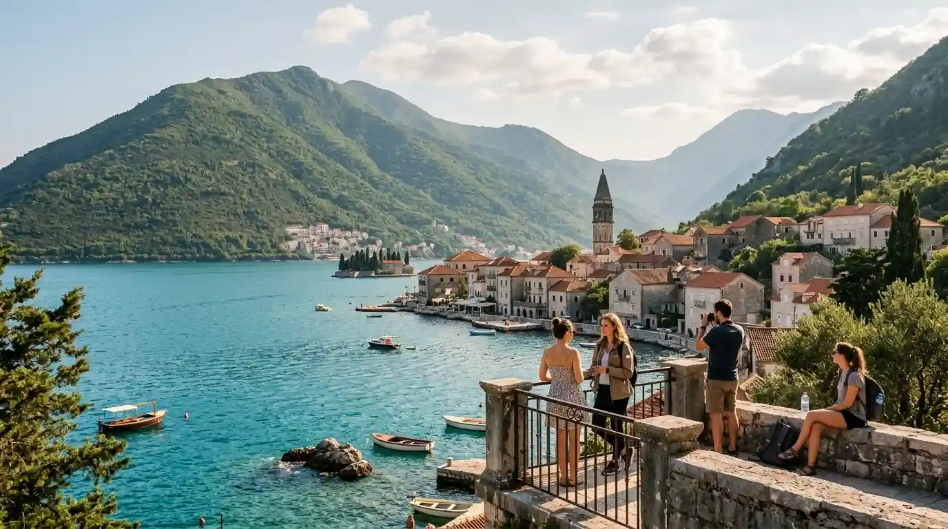 Scenic coastal destination with turquoise water, a historic waterfront town, and green mountains.